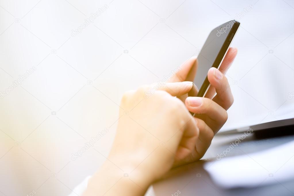 Close up of a woman using smartphone