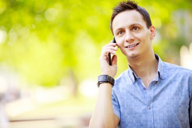 cep telefonuyla konuşan yakışıklı genç adam