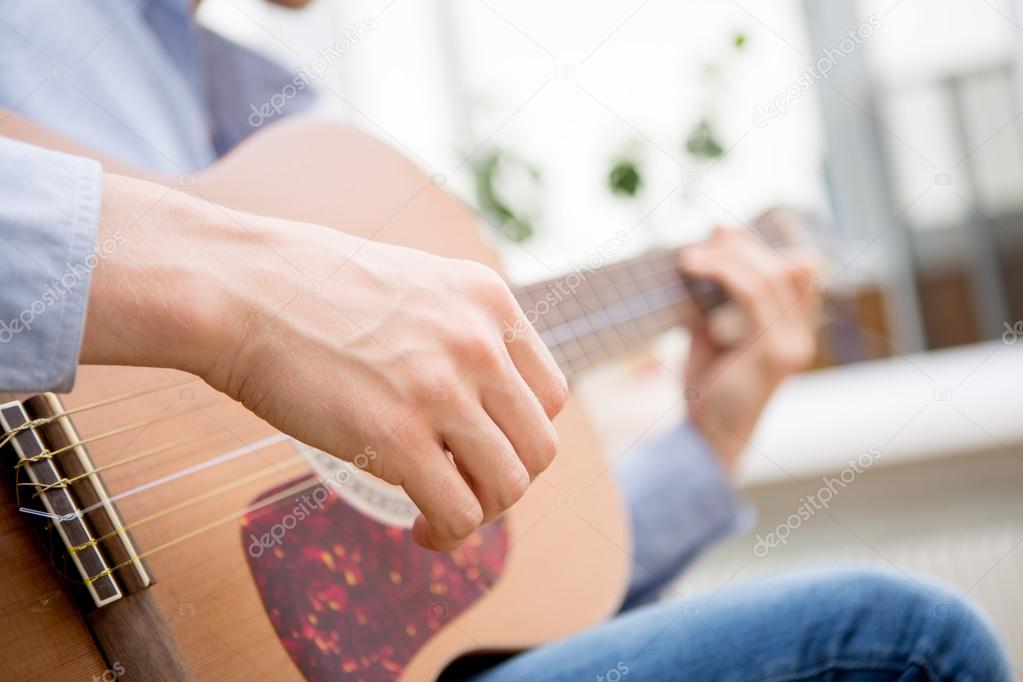 Man playing classic, acoustic guitar