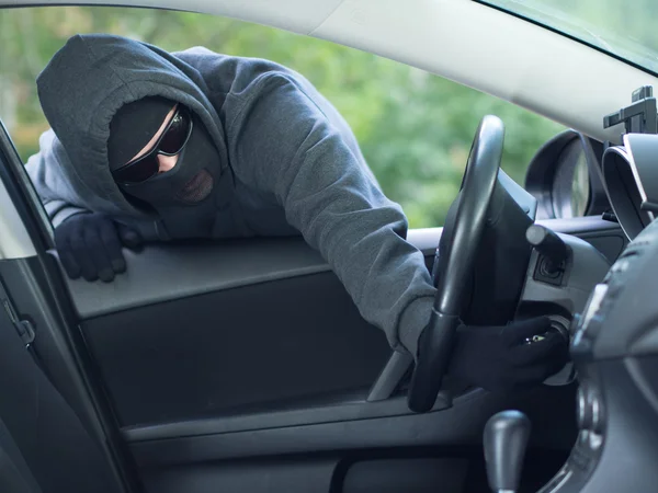 Burglar wearing mask balaclava, car burglary Stock Image