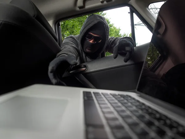 Brottslighet koncept - tjuv stjäla laptop från bilen. Visa från laptop — Stockfoto