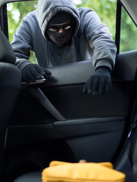 Transportation crime concept .Thief stealing bag from the car — Stock Photo, Image