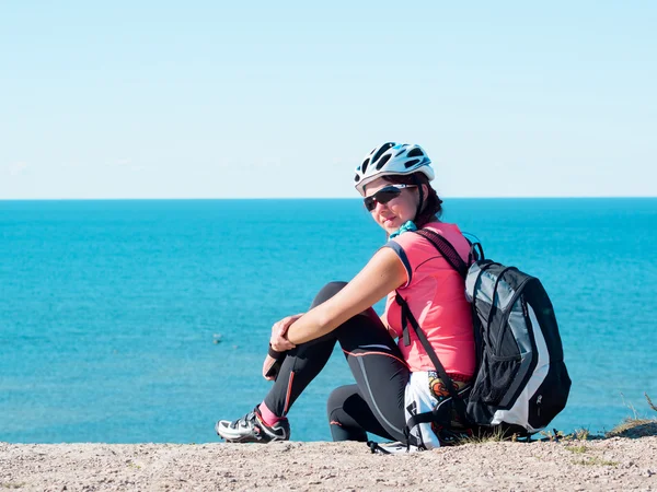 Frau sitzt auf Felsen über Meereslandschaft — Stockfoto