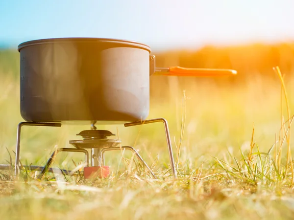 Can on portable camping stove — Stock Photo, Image