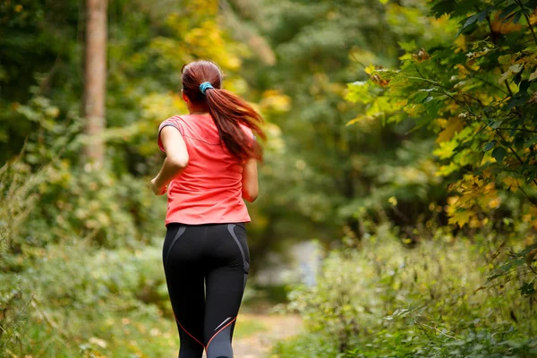 Sporty  woman running in forest — Stock Photo, Image