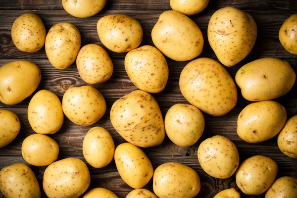 Potatis på trä bakgrund — Stockfoto