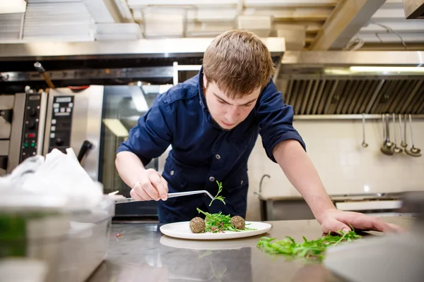 Closeup man garnishing food — Stock Photo, Image