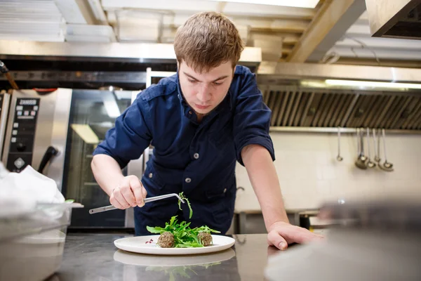 Closeup man garnishing food — Stock Photo, Image