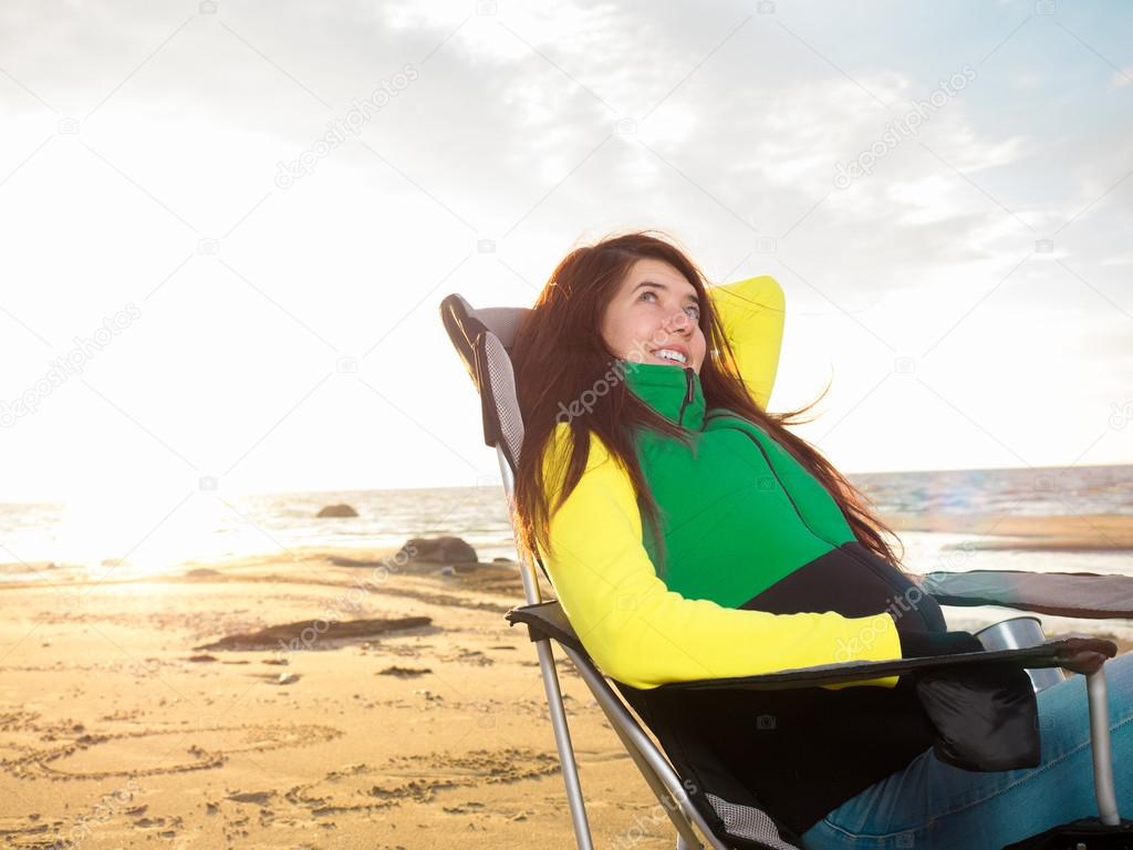Beautiful woman sitting on beach