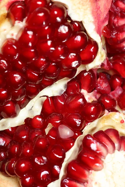 Ripe and juicy pomegranate broken into pieces, closeup — Stock Photo, Image
