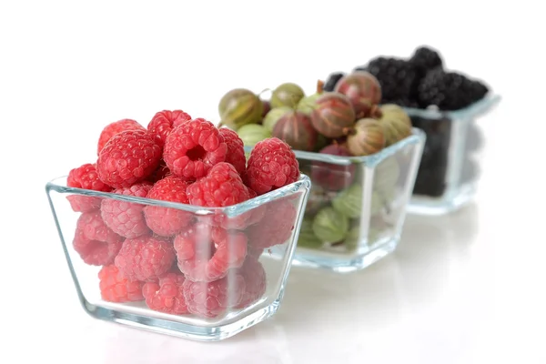 Raspberry, blackberry och krusbär i glas koppar — Stockfoto