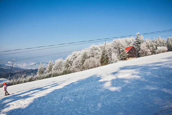 Skier in red helmet standing on lift — Stock Photo, Image