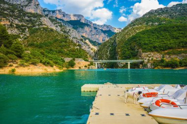 Wooden pier with white catamaran
