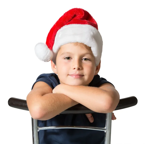 Charmante jongen in rode kerstmuts — Stockfoto