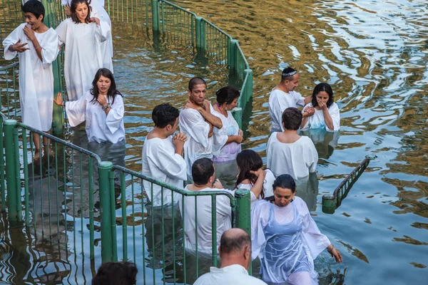They enter the water, dressed in white robes — Stock Photo, Image