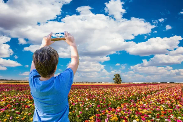 Teenager Blue Shirt Photographs Mobile Phone Spring Flower Fields Garden — Stock Photo, Image