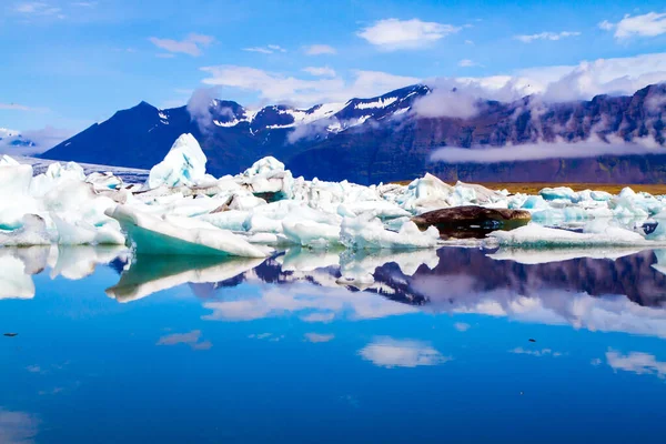 白色和蓝色的冰山和浮冰反映在水面上 泻湖的Jokulsaurloun 冰上覆盖着火山灰 北方旅游和摄影旅游的概念 — 图库照片