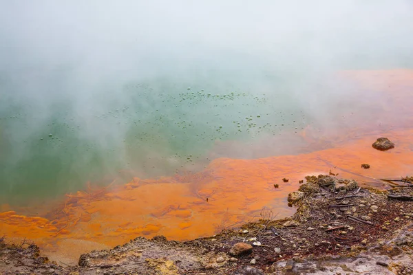 Hot lake with gas bubbles and orange shore. Thermal Wonderland Champagne. Wai-O-Tapu, New Zealand. The geothermal zone of Rotorua. The concept of exotic, ecological and photo tourism