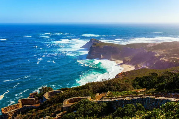 South Africa. Powerful ocean surf. Cape of Good Hope at the southern tip of the Cape Peninsula. White foam of the ocean surf. Bird\'s-eye view. Bright sunny summer february day