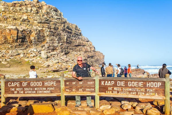 CAPE OF GOOD HOPE, SOUTH AFRICA - APRIL 23, 2016: The Cape of Good Hope at the southern tip of the Cape Peninsula, South Africa. Crowd of tourists are photographed on the famous rocks