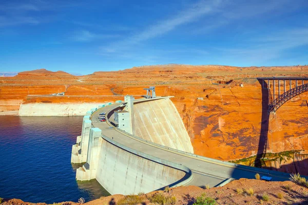 The best journey in life. Glen Canyon Bridge over the Colorado River next to the Glen Canyon Dam. The red sandstone is the base of the bridge. The concept of active and photo tourism