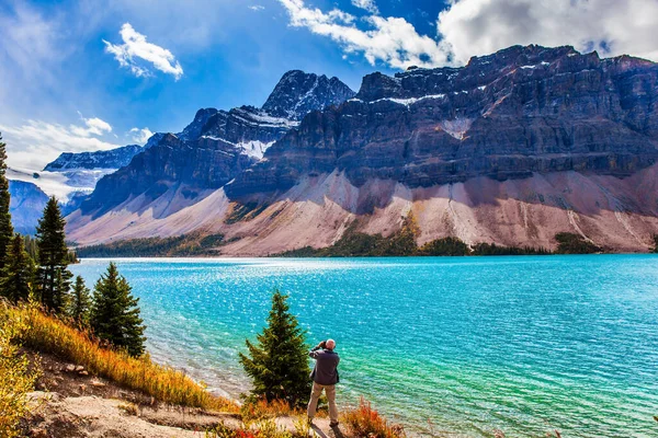加拿大雄伟的落基山脉 一张灰白头发的游客照片展现了一幅宏伟的风景 弓湖被悬崖和冰川环绕着 环境和摄影旅游的概念 — 图库照片