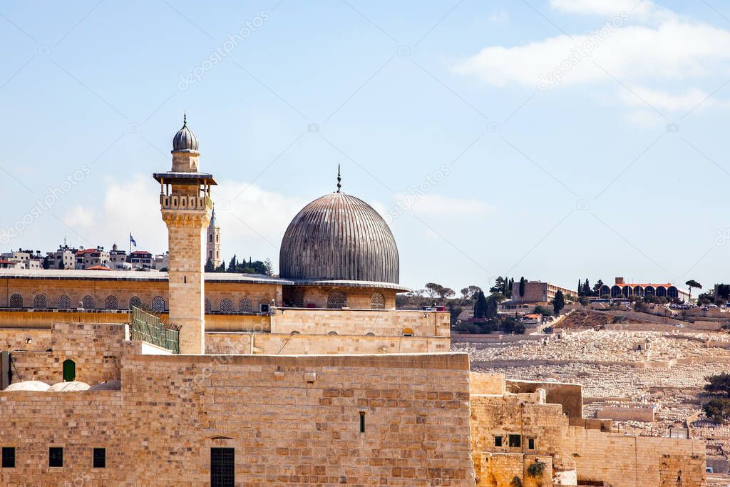 The famous black dome of the Al-Aqsa Mosque located on the Temple Mount. Ancient Jerusalem. The roofs of the old city. Warm sunny day