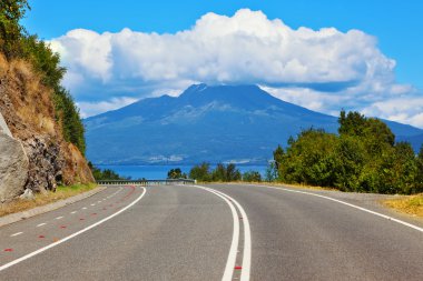 Road leads to volcano Osorno clipart