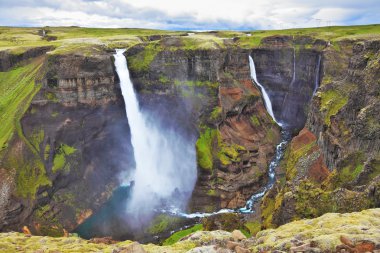 The waterfall flies on black stones