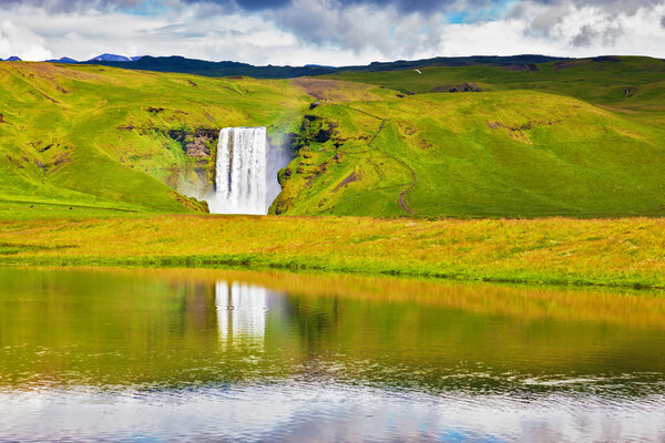 waterfall Skogafoss near road
