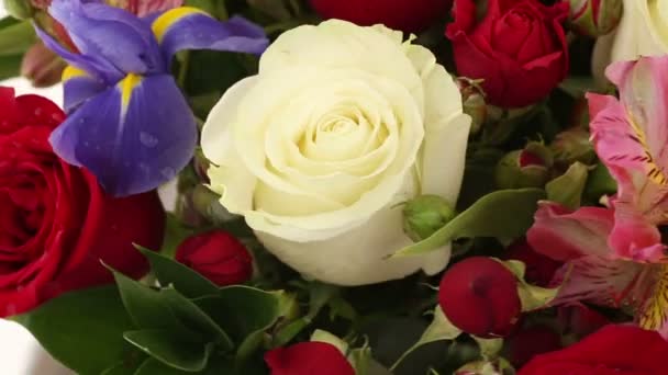 Beautiful bouquet roses, iris and alstroemeria rotates.