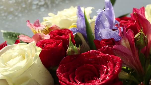 Druppels water vallen op mooi bouquet van rozen, iris en alstroemeria. — Stockvideo