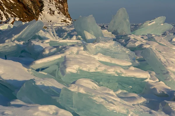 Clumps of blue ice on the snow. — Stock Photo, Image