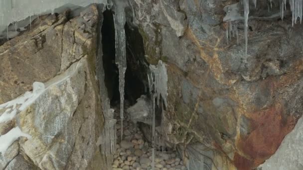 Höhlen und Risse im Fels mit Eiszapfen. — Stockvideo
