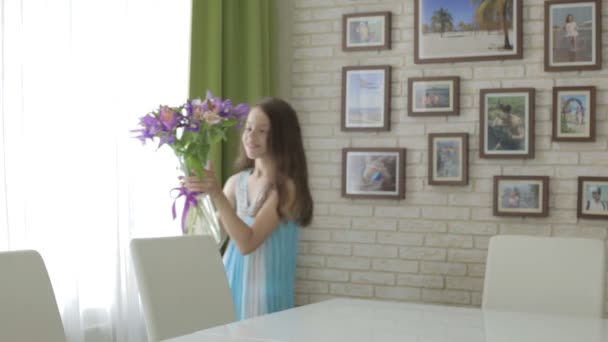 Beautiful girl brought in gift bouquet of flowers. — Stock Video
