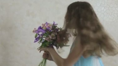 Güzel kız bağışlanan buket çiçek ve swirls sevinir.