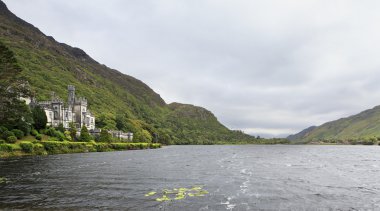 Kylemore Abbey in mountains on the lake. clipart