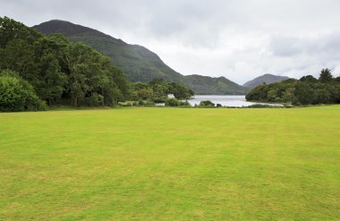 Green lawn in front of Muckross Lake. clipart