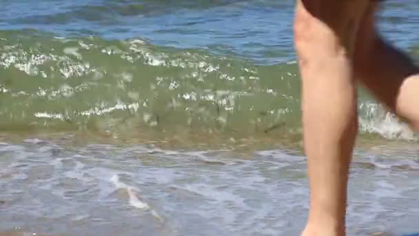 Legs of tourists passing on background Aegean Sea. Northern Greece. — Stock Video