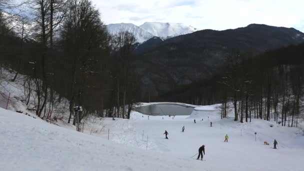 Ski slopes and artificial lake in Rosa Khutor Alpine Resort — Stock Video