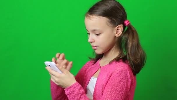 Little girl writing short message on mobile phone — Stock Video