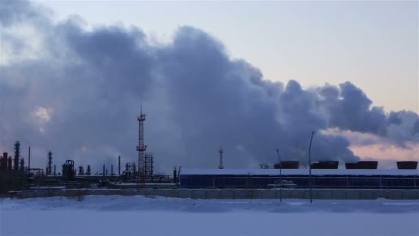 Refinería al atardecer fondo cielo. Tarde nevada helada de invierno. Panorama horizontal — Vídeo de stock