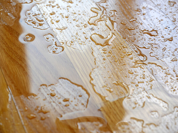 Parquet. Water drops on wooden surface. 