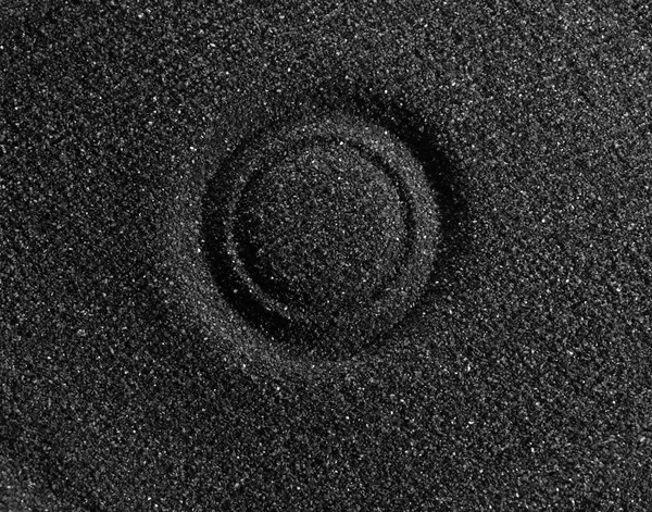Black sand.  Close-up.