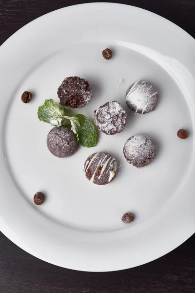 Candy hand cooking on a white plate — Stock Photo, Image