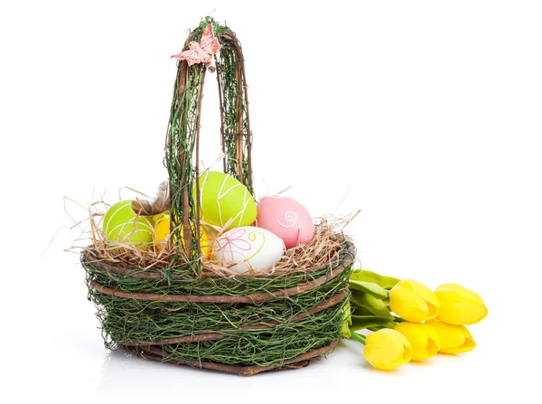 Easter eggs basket and tulips — Stock Photo, Image