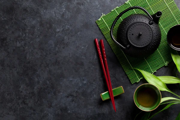 Green tea and sushi chopsticks — Stock Photo, Image