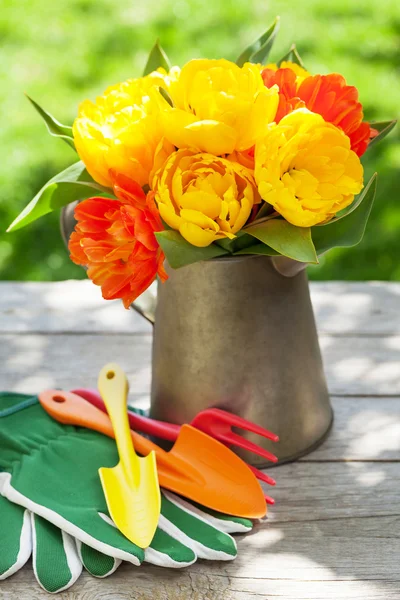 Tulips and garden tools — Stock Photo, Image