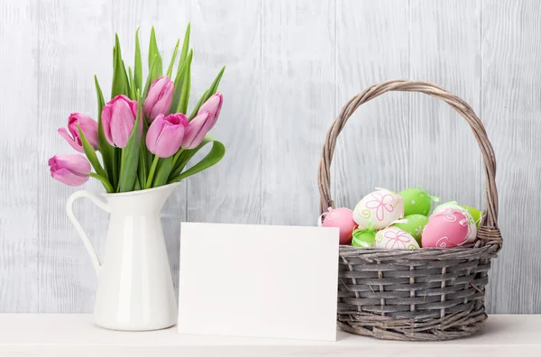 Easter eggs, greeting card and pink tulips — Stock Photo, Image