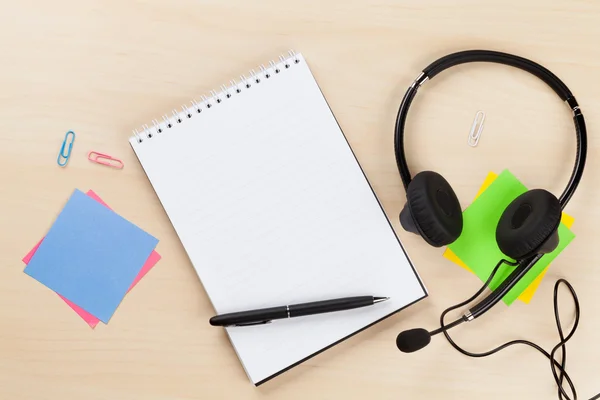 Office desk with headset and supplies — Stock Photo, Image